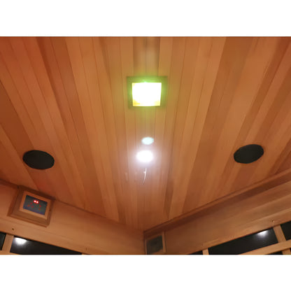 Wooden ceiling with a light fixture and speakers